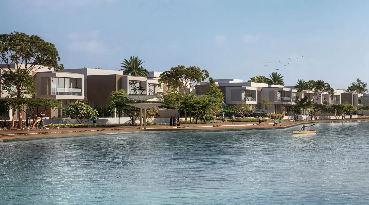 Waterfront villas and promenade with kayaker on the lagoon at Bayn by Ora, Ghantoot, between Abu Dhabi and Dubai